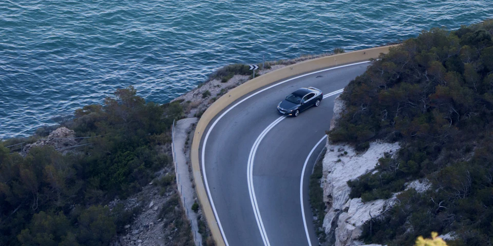 Bil Til a coastal road beside the sea